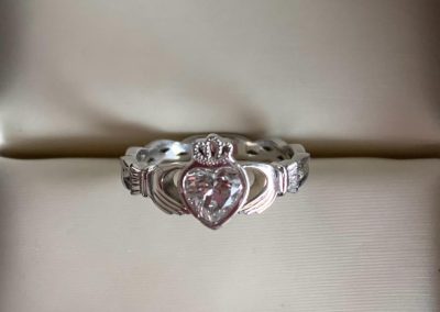 Elegant heart-shaped diamond engagement ring with intricate band design.