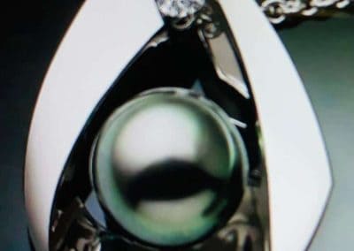 Pearl pendant necklace with diamond accent, perfect for jewelry repairs and custom designs.
