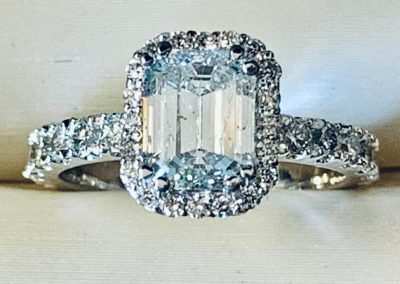 Beautiful diamond ring with halo setting and intricate band design.